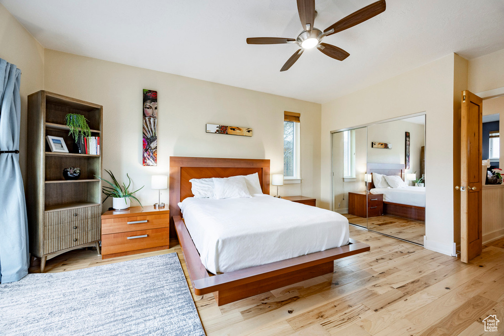 Bedroom featuring light wood-type flooring, a closet, and a ceiling fan