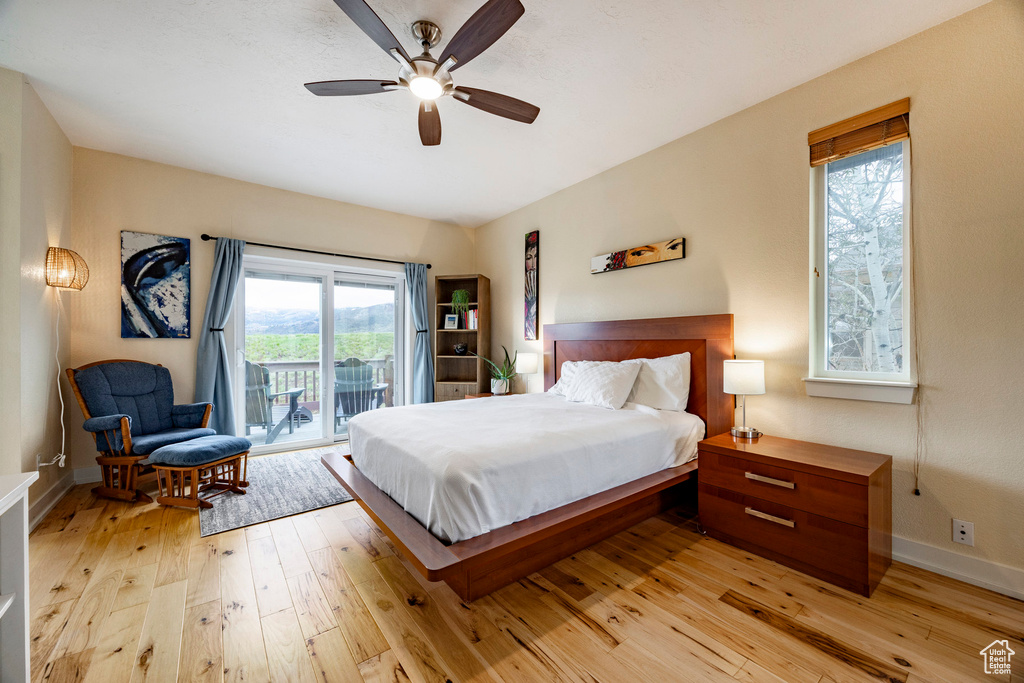 Bedroom with access to outside, light wood-style floors, baseboards, and ceiling fan