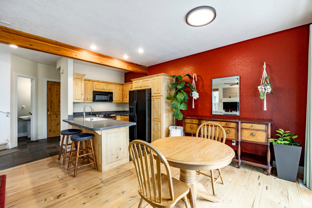 Dining area with beamed ceiling, recessed lighting, baseboards, and light wood finished floors