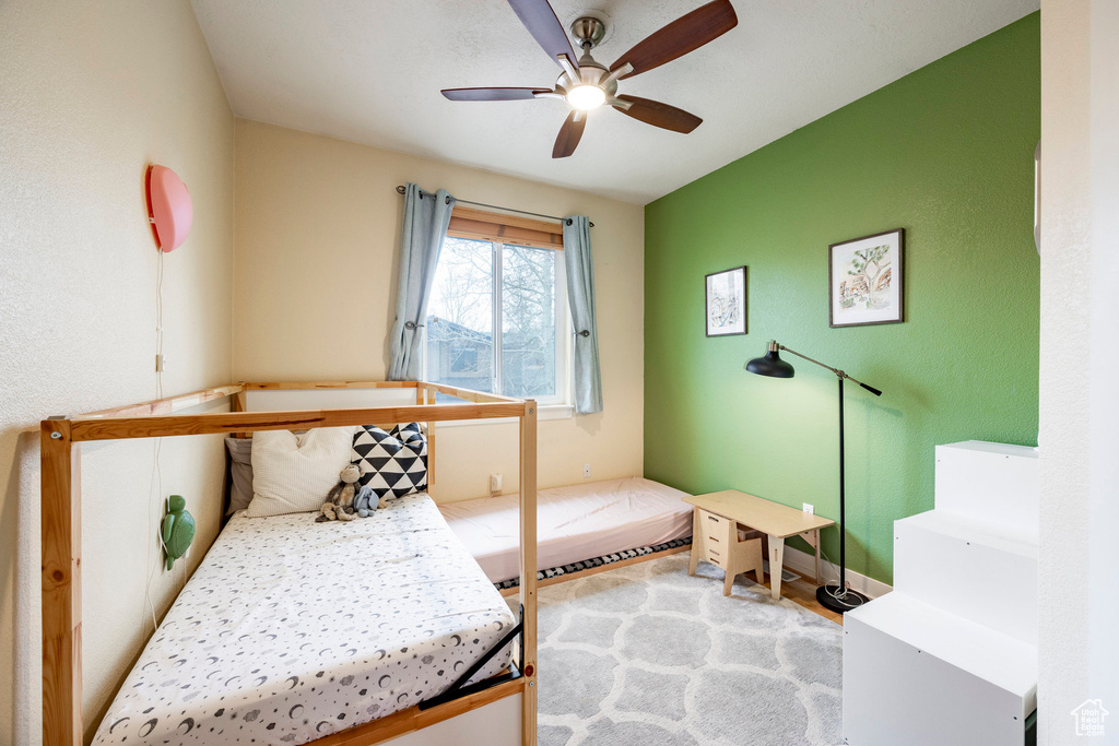 Bedroom with ceiling fan and wood finished floors