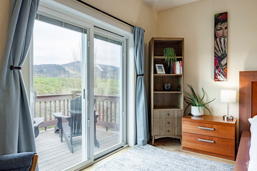 Entryway with plenty of natural light, wood finished floors, and a mountain view