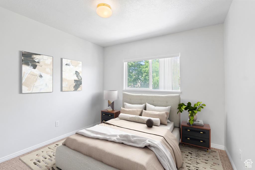 Bedroom featuring carpet flooring and baseboards