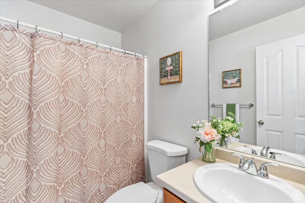 Full bathroom with toilet and vanity