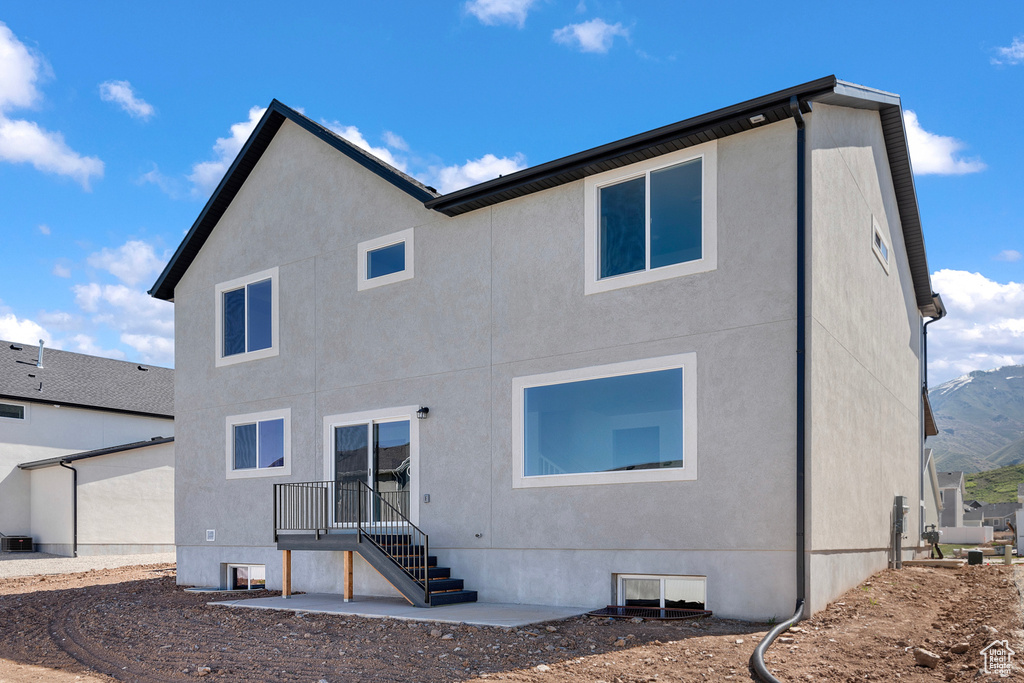Rear view of house with stucco siding