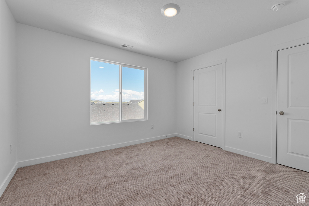 Unfurnished bedroom featuring carpet floors and baseboards