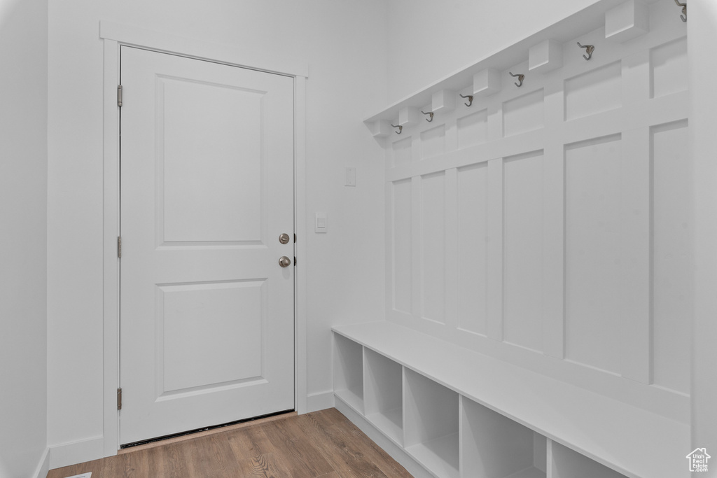 Mudroom with wood finished floors and baseboards