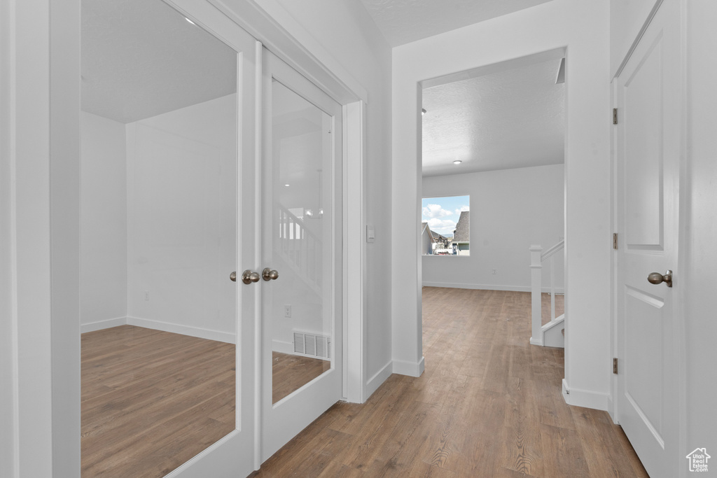 Hall featuring wood finished floors and baseboards