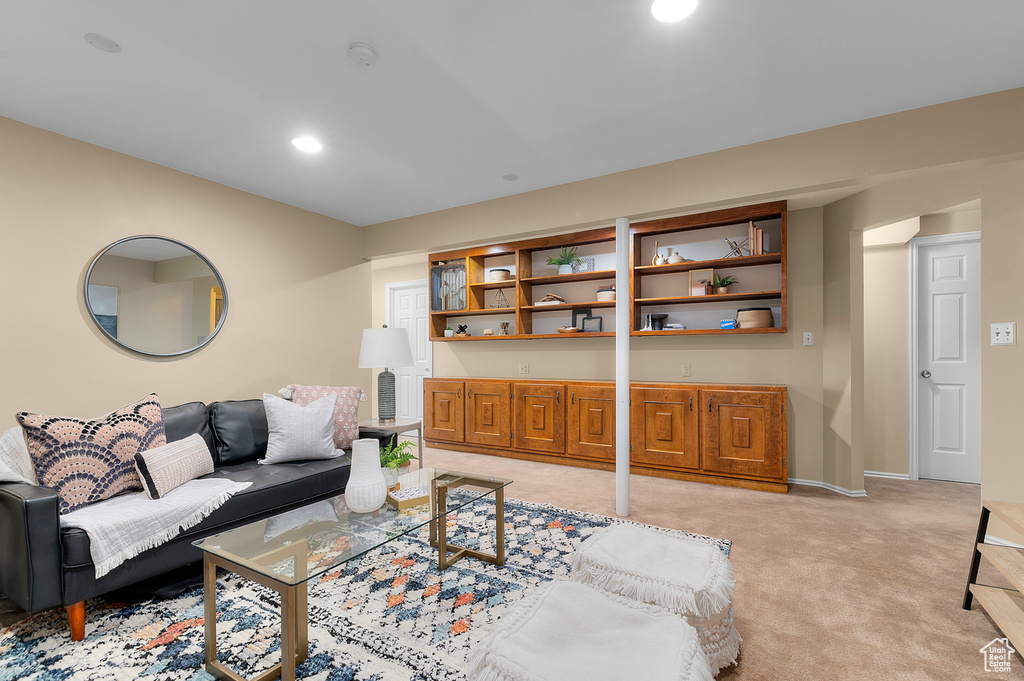 Living area with light colored carpet and baseboards