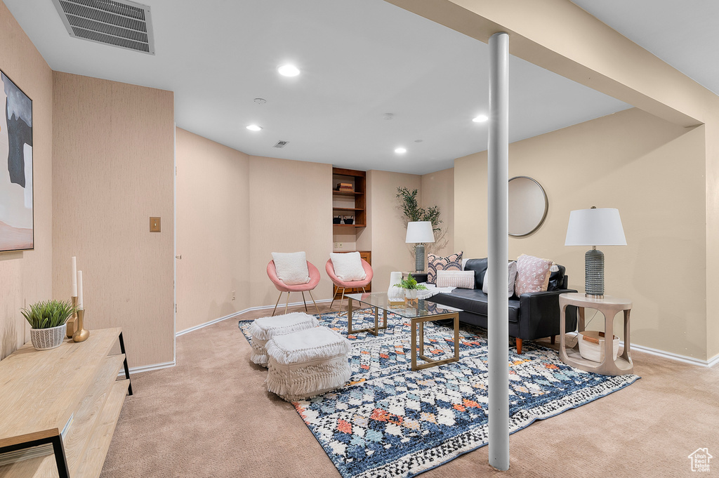 Living area with carpet flooring, baseboards, and recessed lighting
