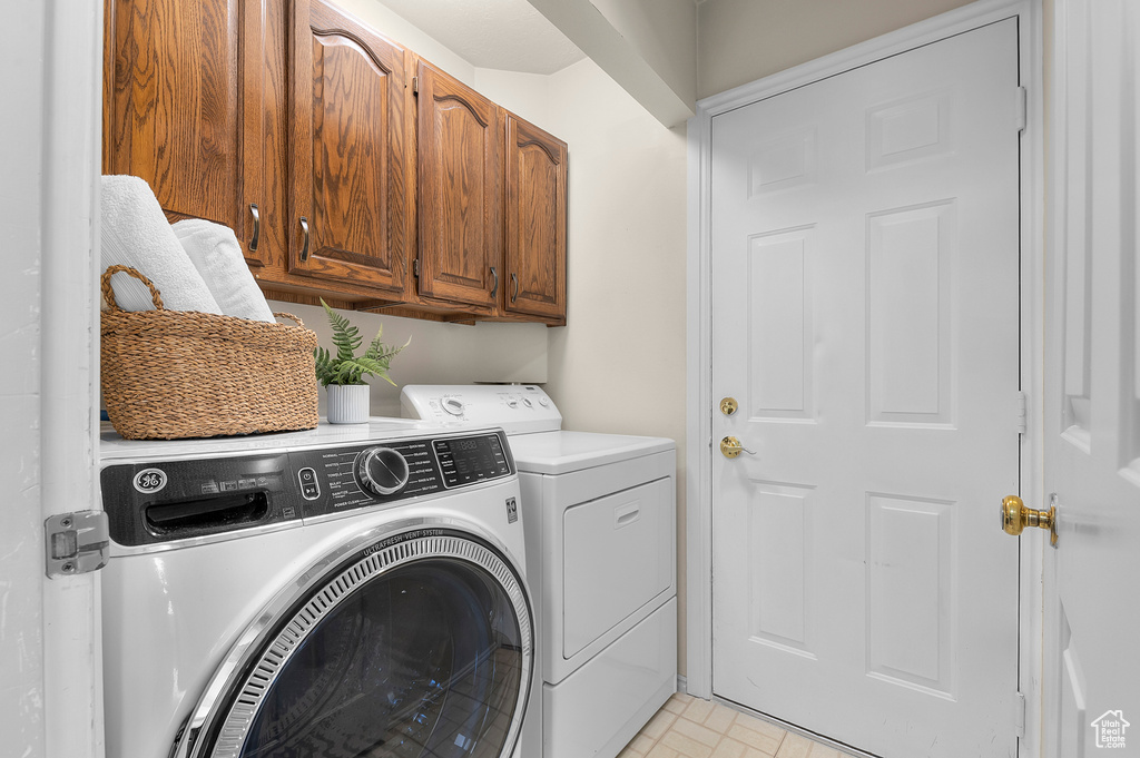 Laundry room with washing machine and clothes dryer and cabinet space