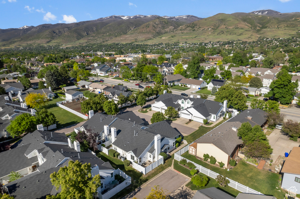 Aerial view of property\'s location featuring nearby suburban area and a mountain backdrop