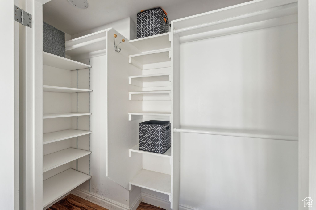 Walk in closet featuring wood finished floors