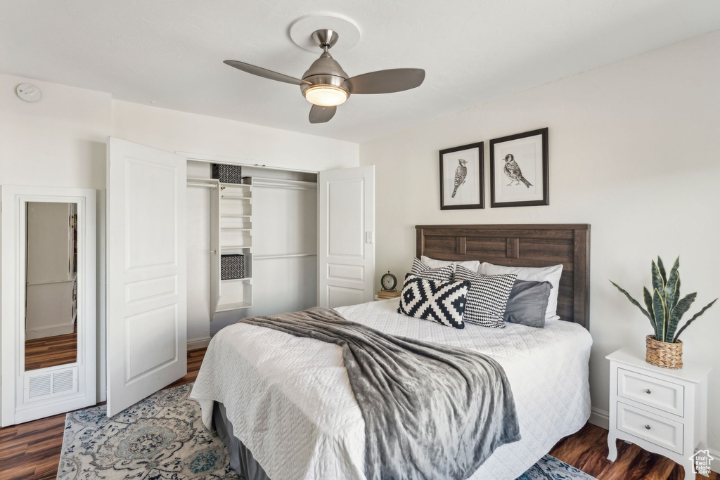 Bedroom with a closet, wood finished floors, and a ceiling fan