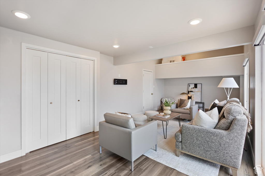 Living area featuring wood finished floors and recessed lighting