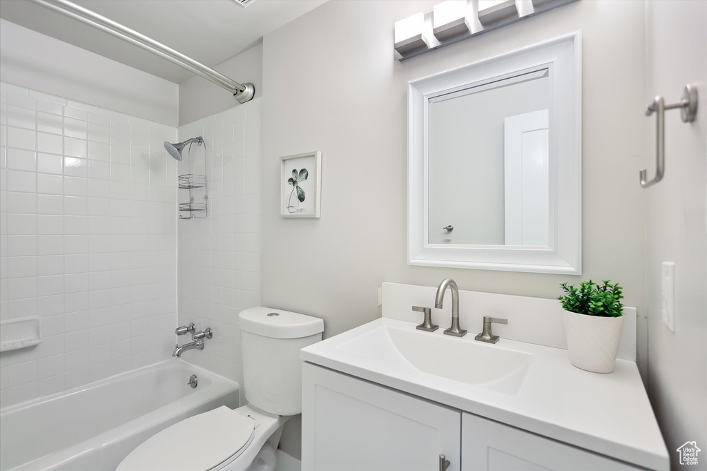 Full bath with toilet, vanity, and shower / tub combination