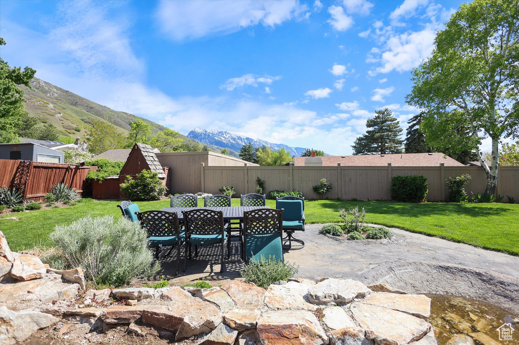 View of patio with a mountain view and outdoor dining space