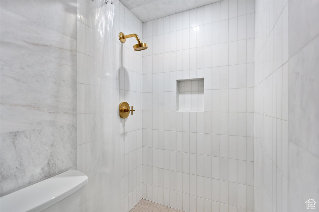 Bathroom with tiled shower and toilet