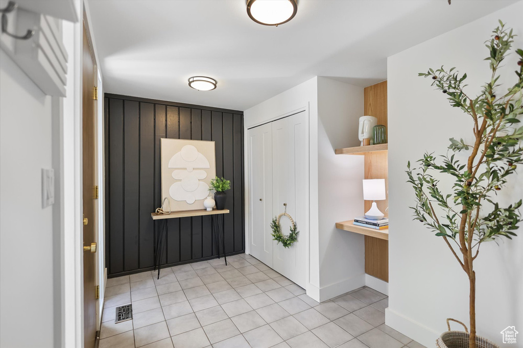 Entryway with light tile patterned floors and baseboards