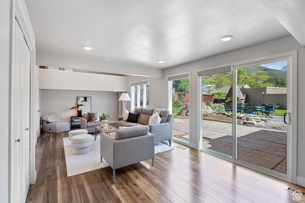 Living area featuring wood finished floors and recessed lighting