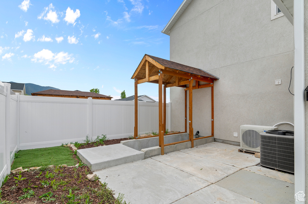 View of patio featuring a fenced backyard, ac unit, and central air condition unit