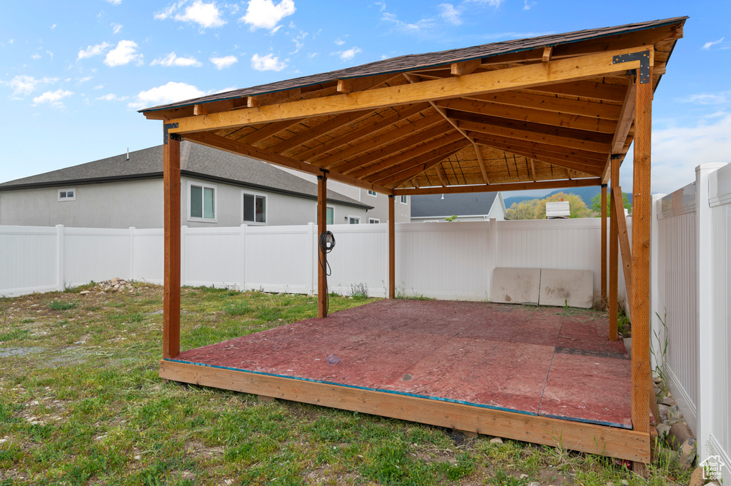View of patio / terrace featuring a fenced backyard, a detached carport, a gazebo, and a wooden deck