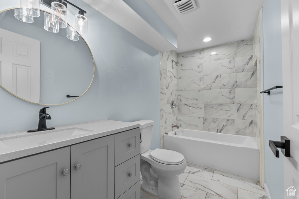 Bathroom with marble finish flooring, vanity, toilet, shower / washtub combination, and recessed lighting