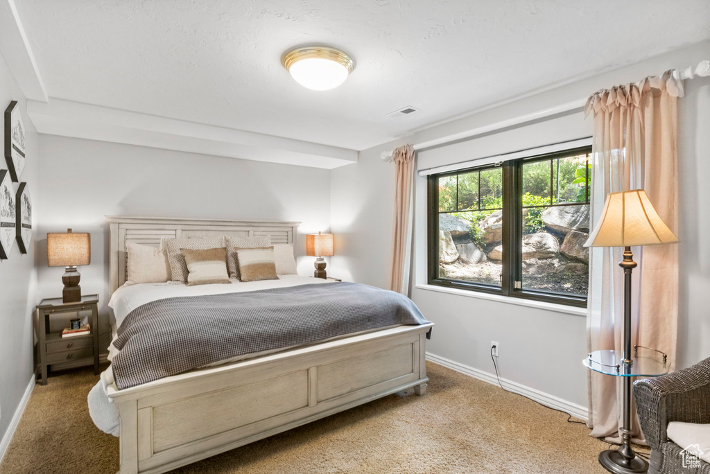 Carpeted bedroom with baseboards