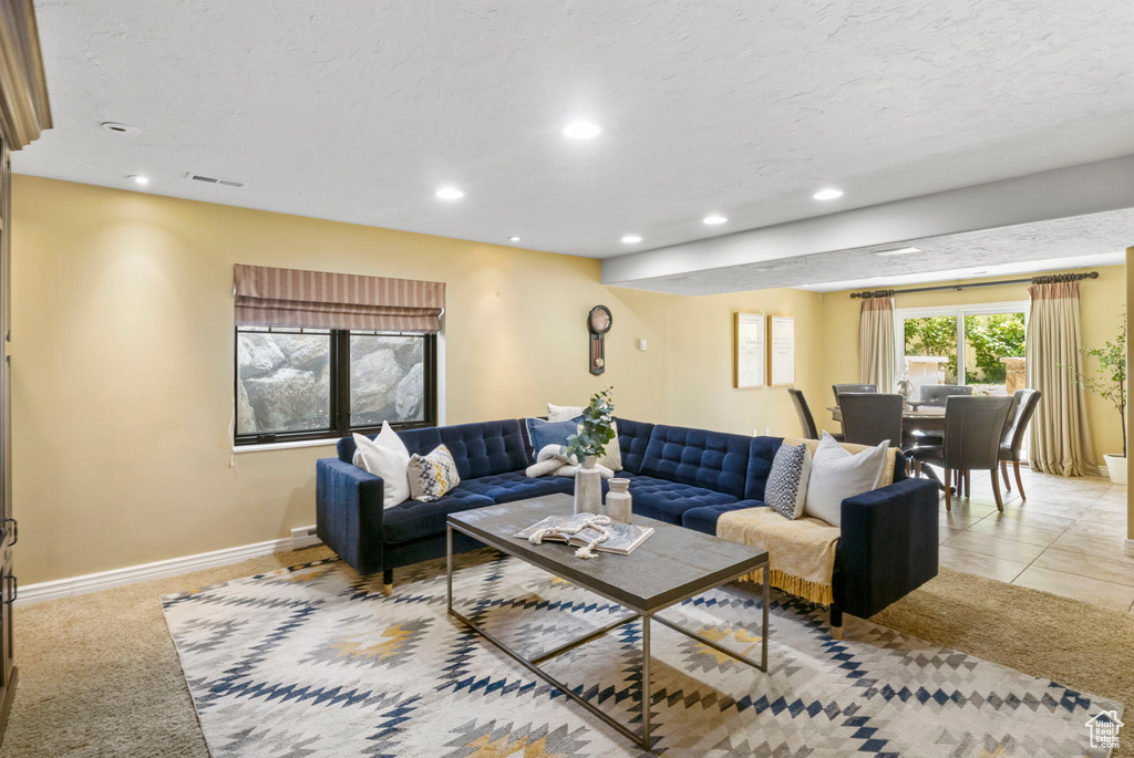 Living room featuring recessed lighting, baseboards, and a textured ceiling