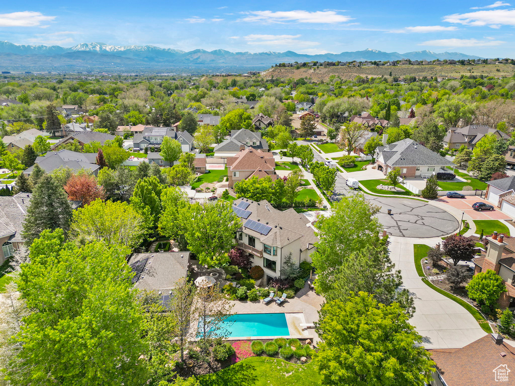 Aerial view of residential area with mountains and a pool