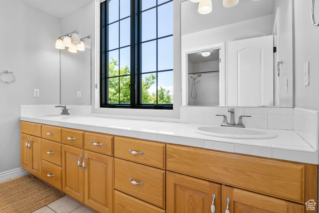 Bathroom featuring double vanity and tile patterned floors