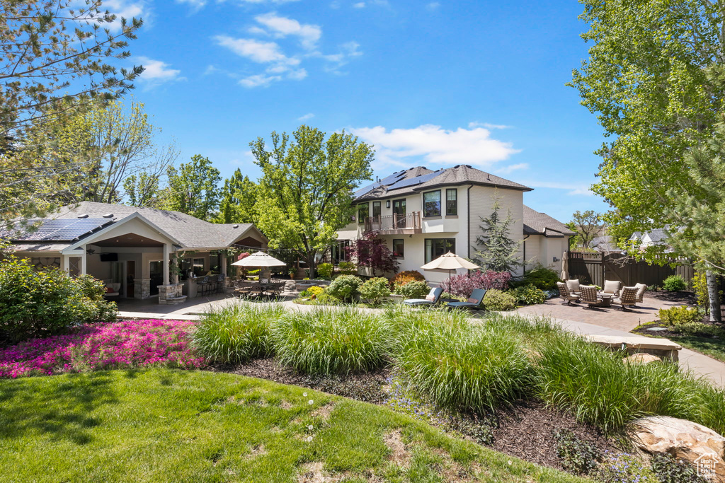 View of yard featuring a patio area, an outdoor living space, and a balcony