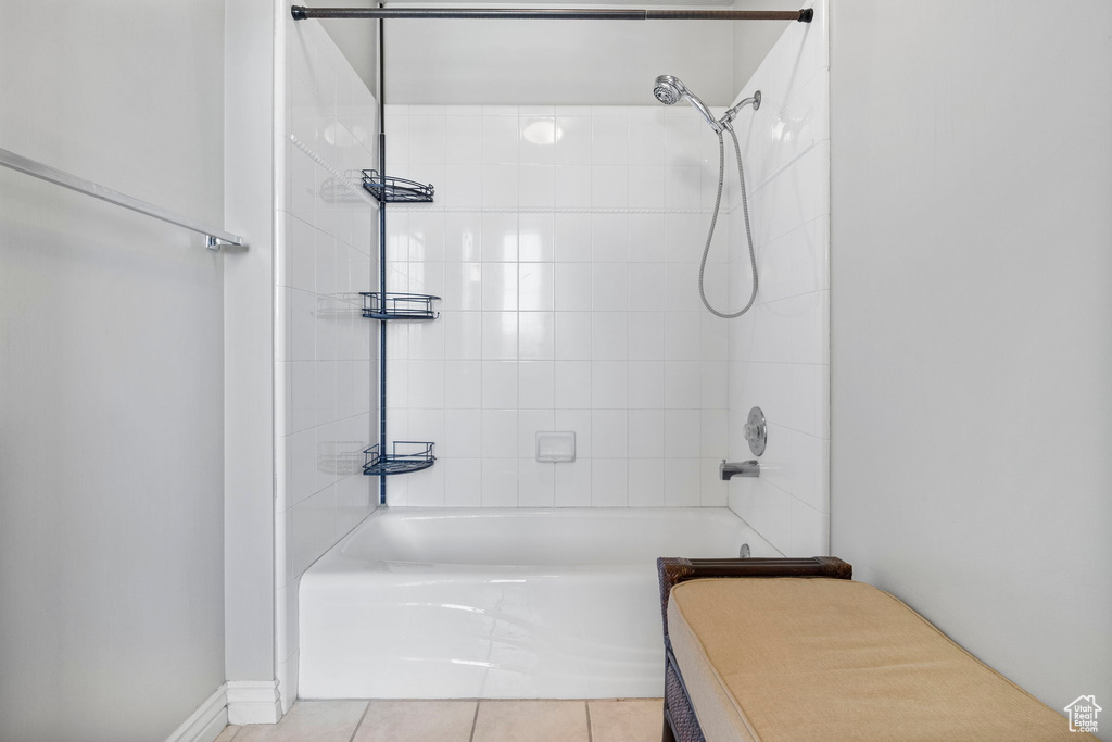 Bathroom with bathing tub / shower combination and tile patterned flooring