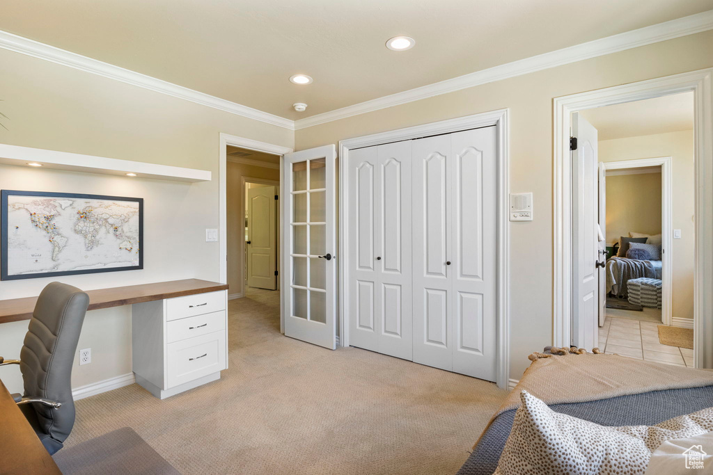 Home office with ornamental molding, recessed lighting, light carpet, baseboards, and french doors