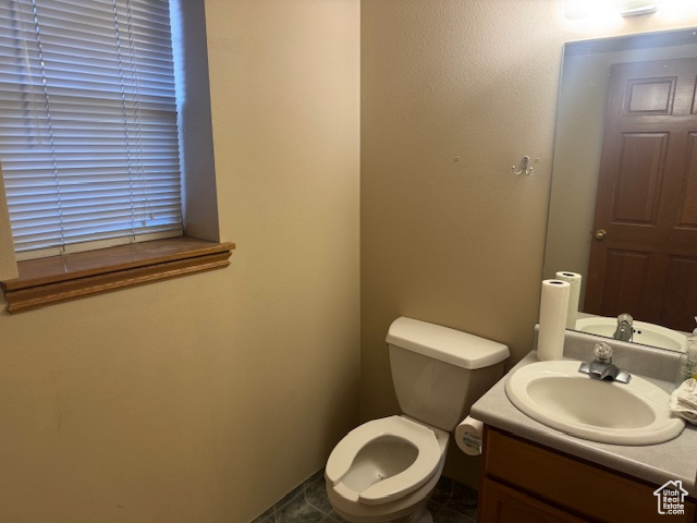 Half bathroom with vanity and toilet