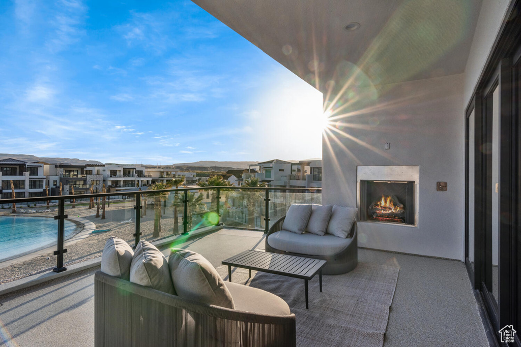 Balcony featuring a high end fireplace and a residential view