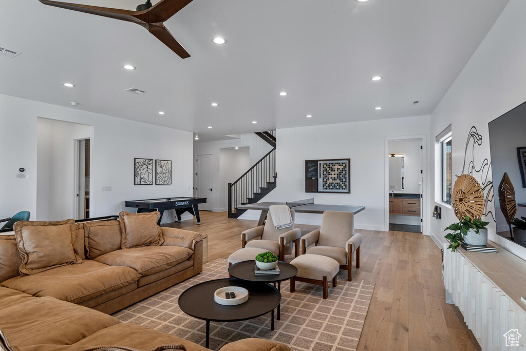 Living area with light wood finished floors, stairway, recessed lighting, billiards table, and baseboards