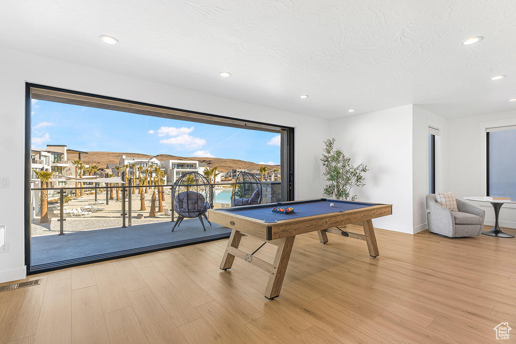 Game room featuring billiards, wood finished floors, recessed lighting, a textured ceiling, and baseboards