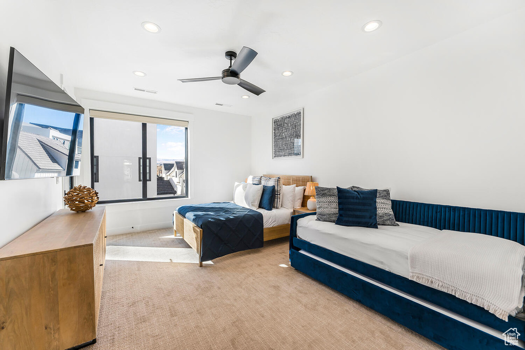 Carpeted bedroom with recessed lighting and a ceiling fan