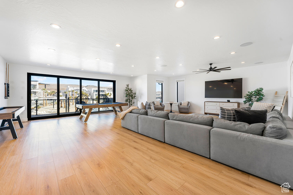 Living room featuring light wood-style floors, recessed lighting, and ceiling fan