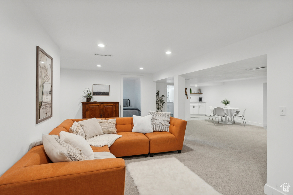 Living area with carpet and recessed lighting