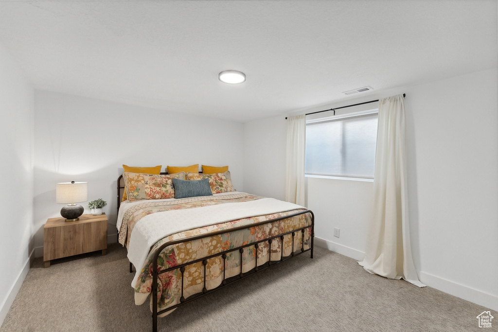 Bedroom featuring carpet flooring and baseboards