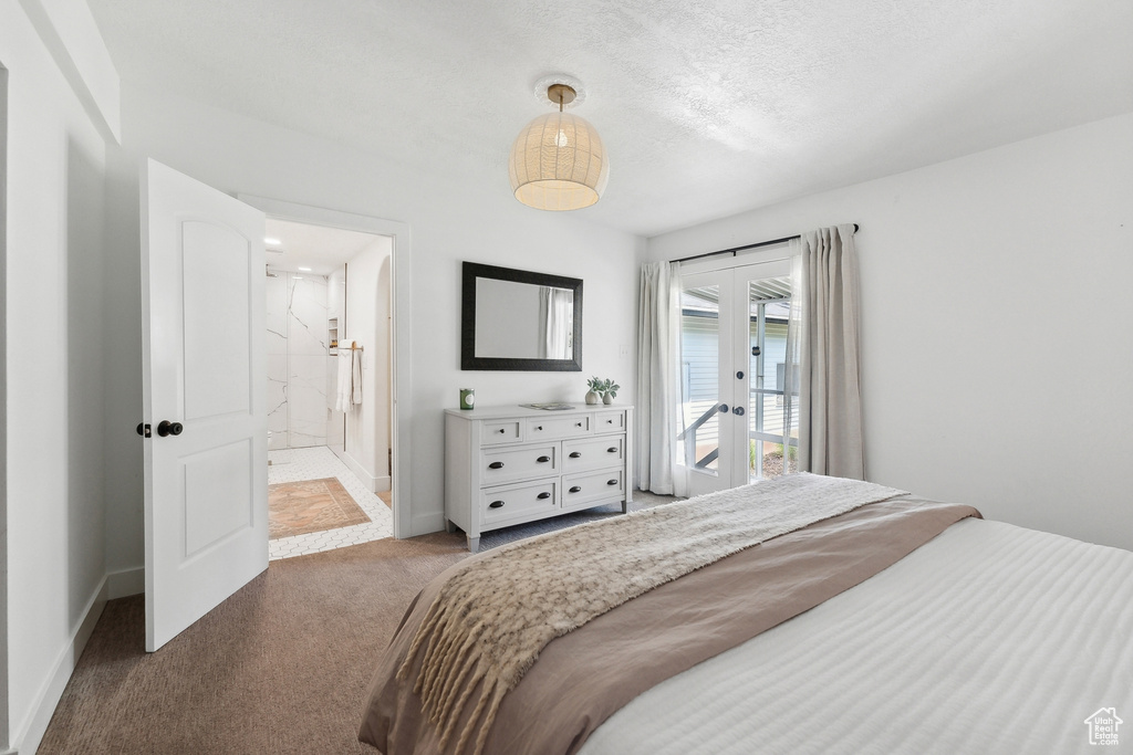 Bedroom featuring carpet, access to exterior, french doors, baseboards, and connected bathroom