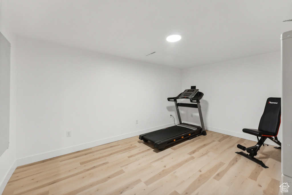 Exercise room with wood finished floors and baseboards