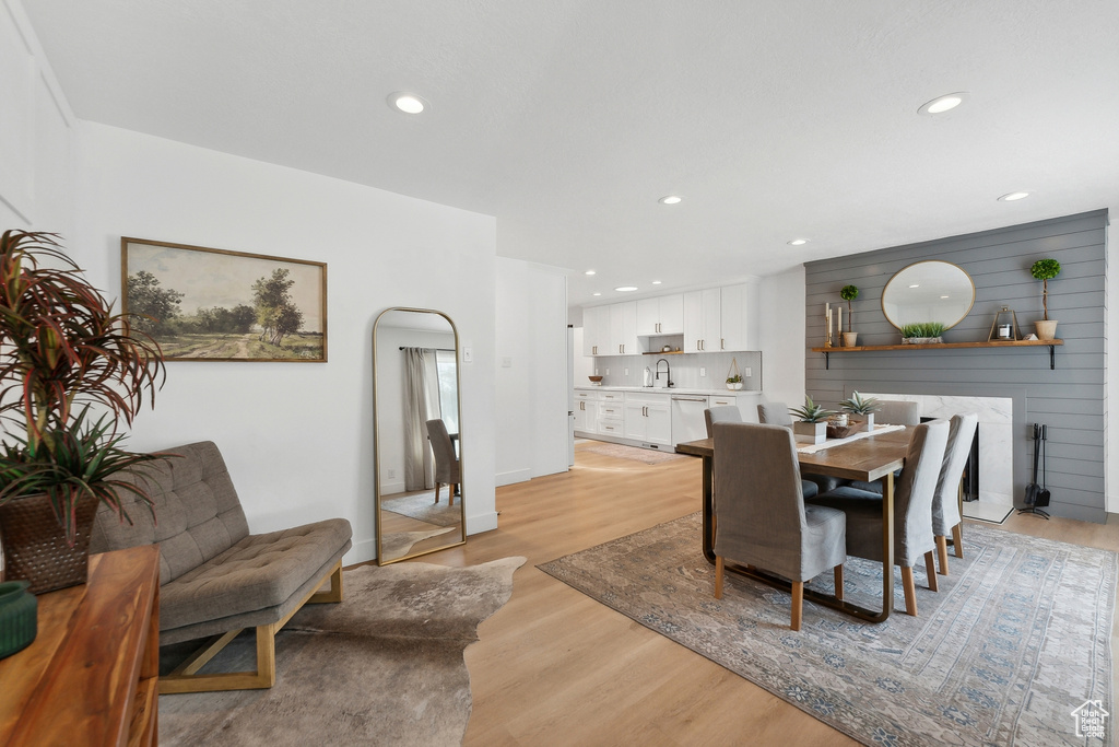 Dining space with light wood finished floors and recessed lighting