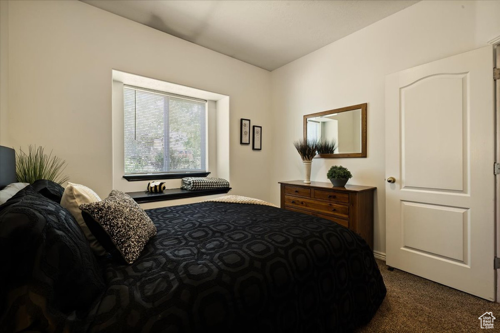 Bedroom with dark carpet