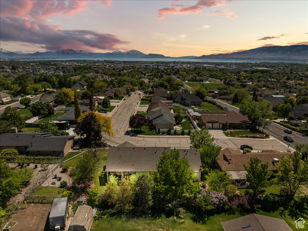 Aerial view of property's location featuring a mountainous background and nearby suburban area
