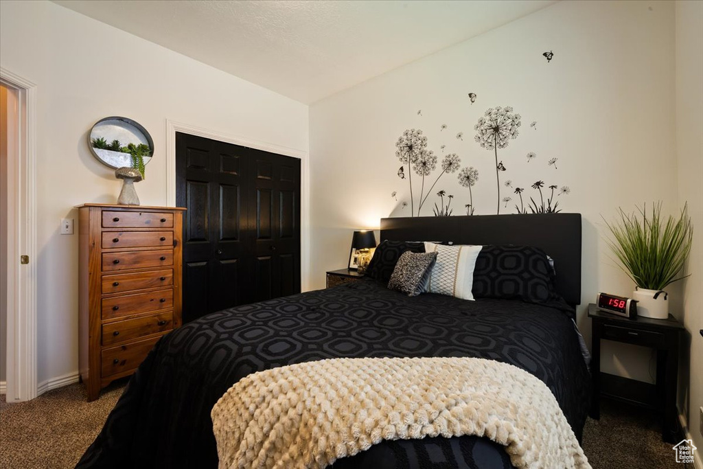 Bedroom featuring carpet, baseboards, and a closet