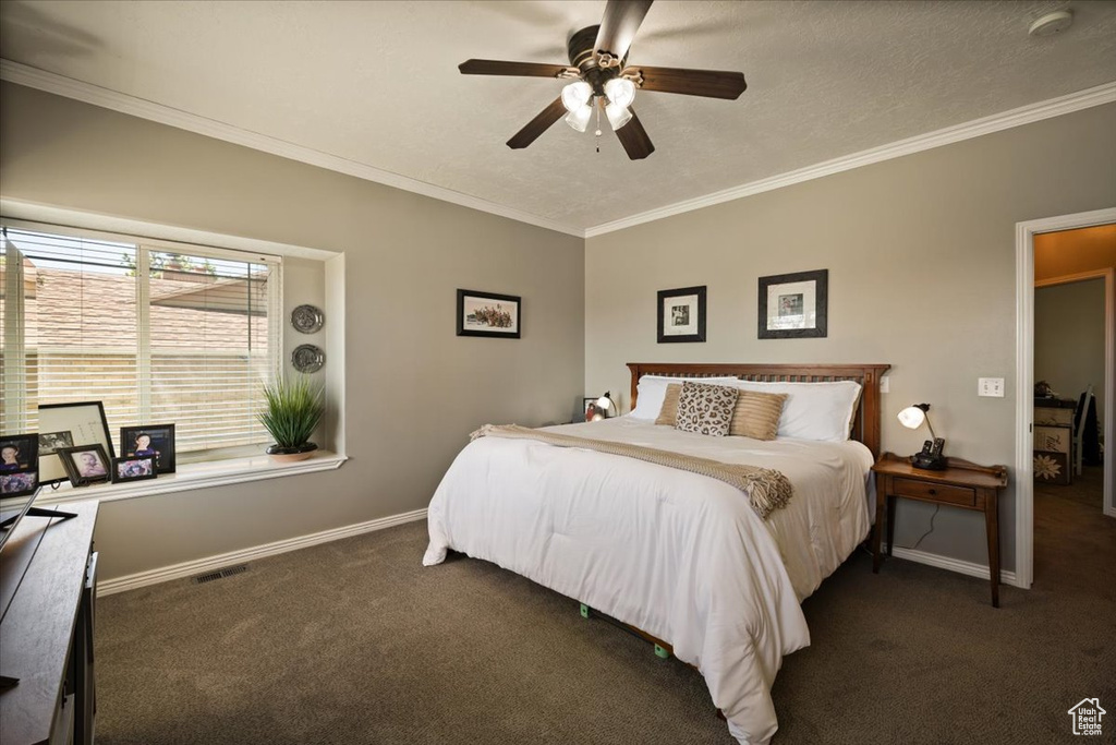 Bedroom featuring carpet floors, ornamental molding, baseboards, and a ceiling fan
