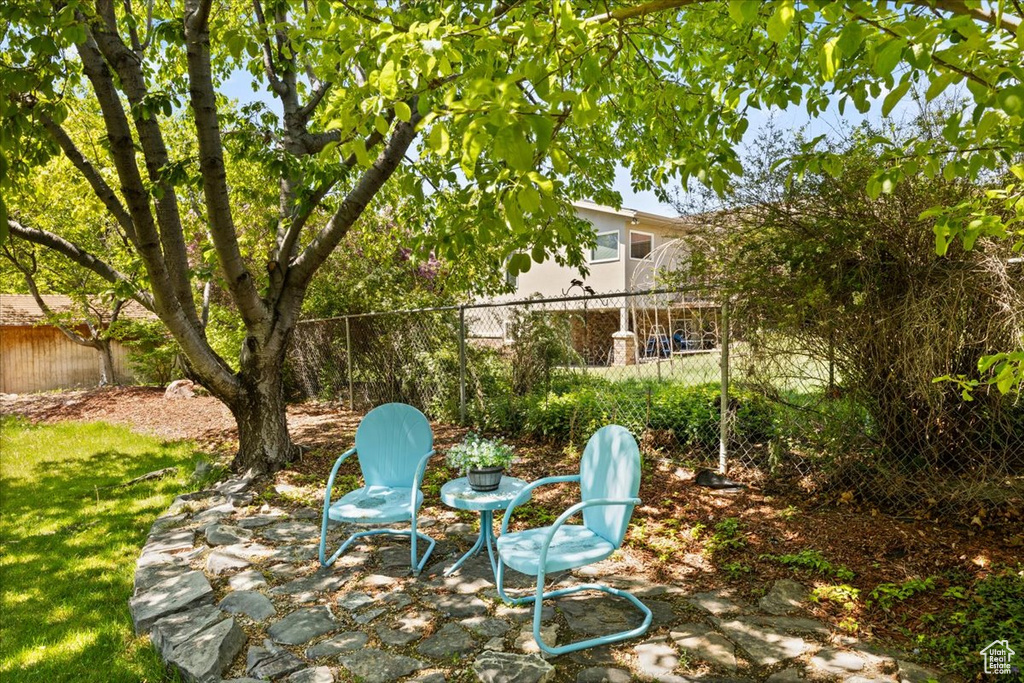 View of yard featuring fence and a patio area
