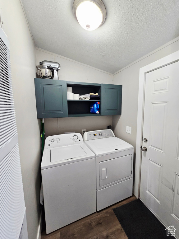 Laundry area featuring washer and clothes dryer, dark wood-style flooring, cabinet space, a textured ceiling, and a heating unit